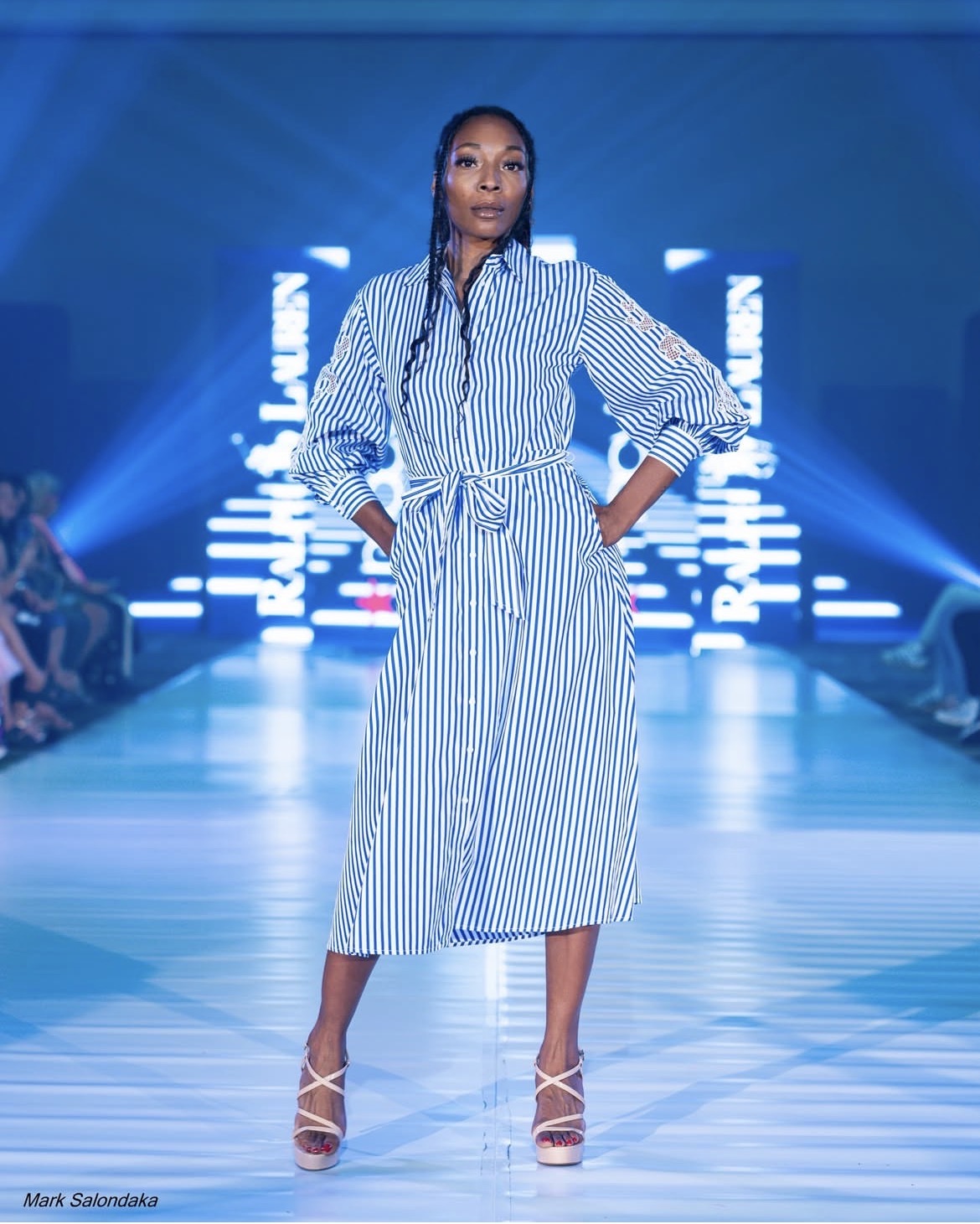 Amari Kelly on the runway in a striped shirt dress