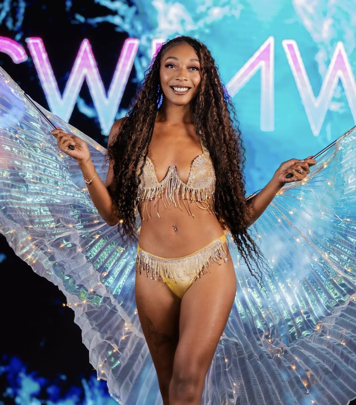 Amari Kelly walking swim week with iridescent wings